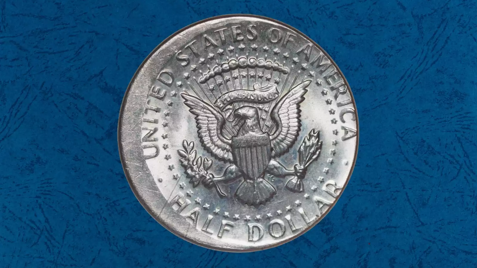 1966 Kennedy half dollar off-center strike error showing design shifted to one side with blank metal crescent